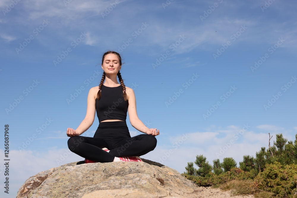 Young woman practicing outdoor yoga in mountains, space for text. Fitness lifestyle Young woman practicing outdoor yoga in mountains, space for text. Fitness lifestyle