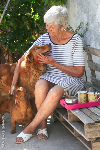 Photography portrait of cheerful senior latino woman having breakfast in her back yard and b