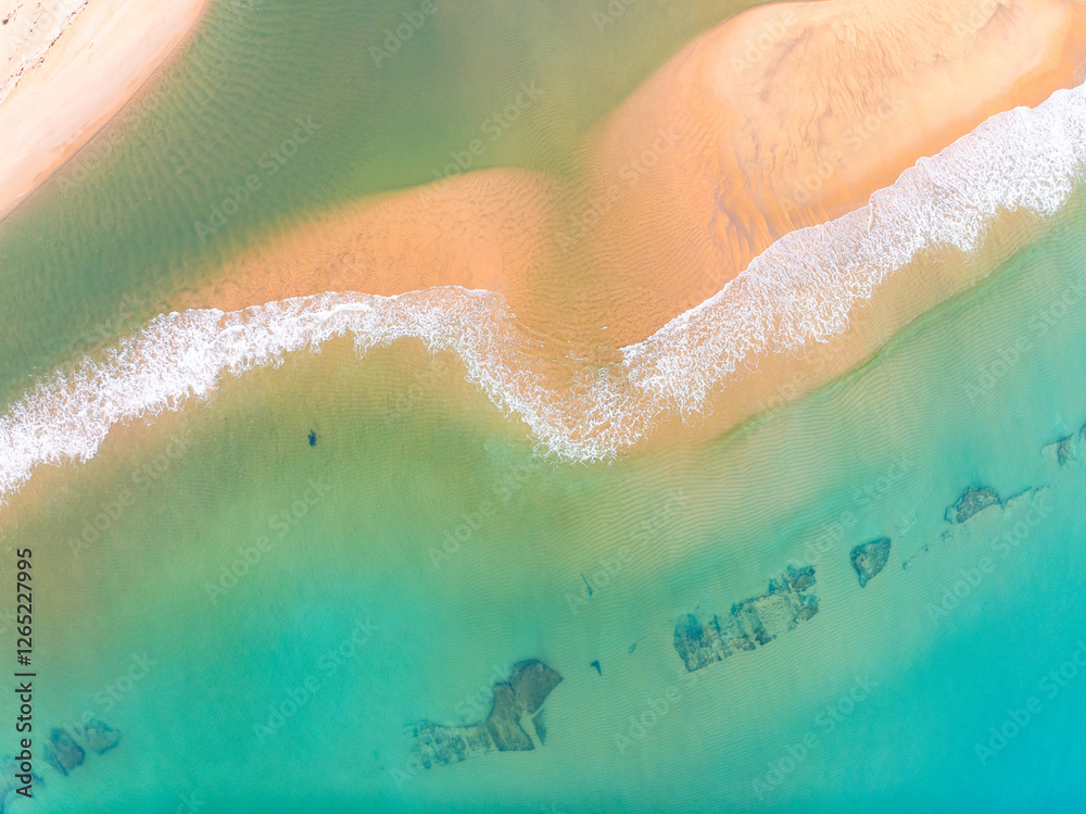 Fototapeta premium Summer seascape beautiful waves,Tropical sea water in sunny day, Top view from drone camera,Amazing ocean colorful nature background, Beautiful bright sea waves splashing on beach sand