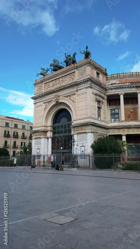 Vertical video of Teatro Politeama Garibaldi in Palermo, Sicily, showcasing its grand neoclassical architecture, bronze chariot sculpture, and intricate facade under a clear blue sky.