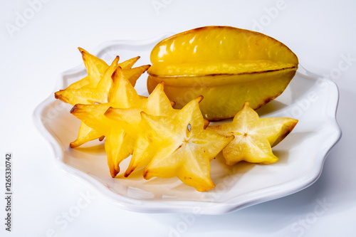 Ripe fresh averrhoa carambola or star fruits on board photo