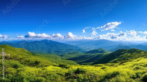 A breathtaking panoramic view of lush green mountains under a clear blue sky
