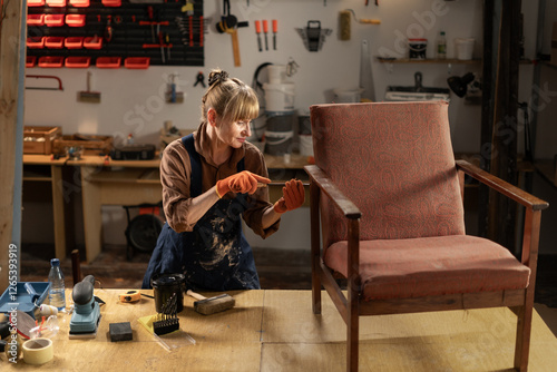 Restoration of wooden furniture in workshop. Middle-aged carpenter restorer working in workshop