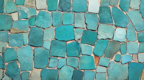 A vibrant turquoise mosaic tile wall showcasing irregular shapes and textures perfect for backgrounds and artistic designs evoking a sense of serenity and visual interest