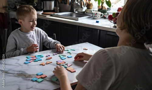 older sister and brother playing logical wooden puzzles