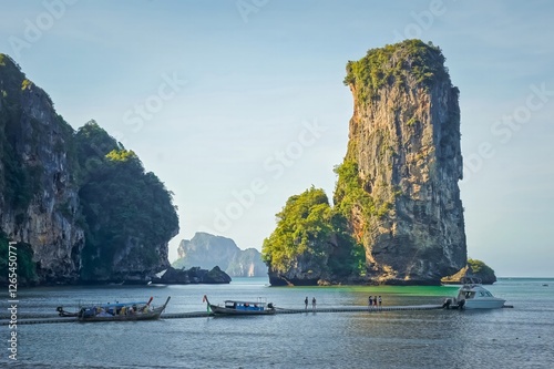 Obraz na płótnie Tourists getting on boats with big rock in the background in Krabi, Thailand w salonie