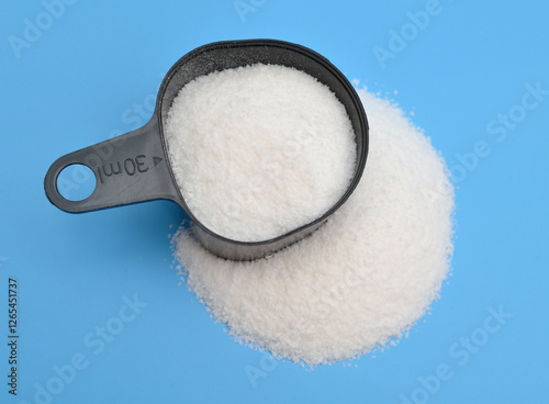 Alkylbenzene sulfonates powder on blue background photo