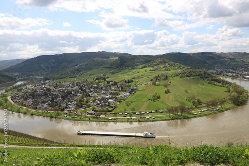 Die Mosel an der Moselschleife bei Kröv / Wolf gesehen aus den Weinbergen im Frühling mit Schlepper / Frachtschiff photo