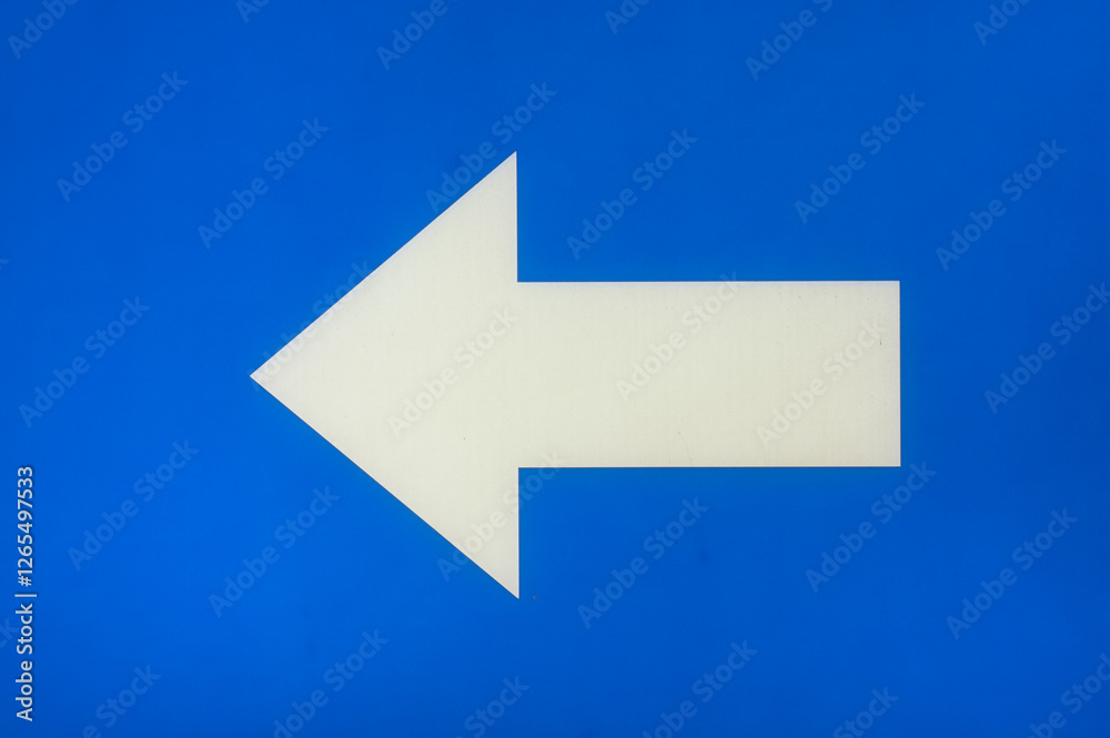white arrow on a blue background pointing to the left white arrow on a blue background pointing to the left
