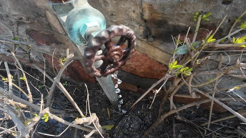 Wallpaper Mural Old Rusty Outdoor Water Faucet with Flowing Water Against a Brick Wall Torontodigital.ca