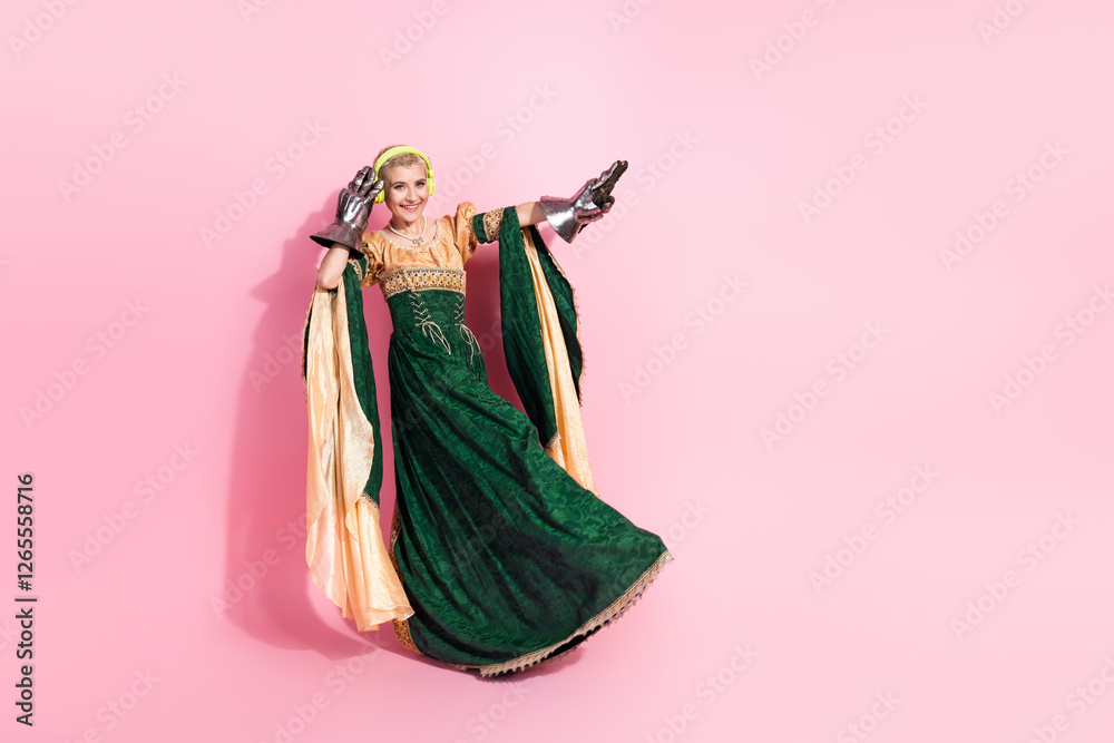 Fototapeta premium Elegant medieval woman in royal attire with modern accessories against a pink background