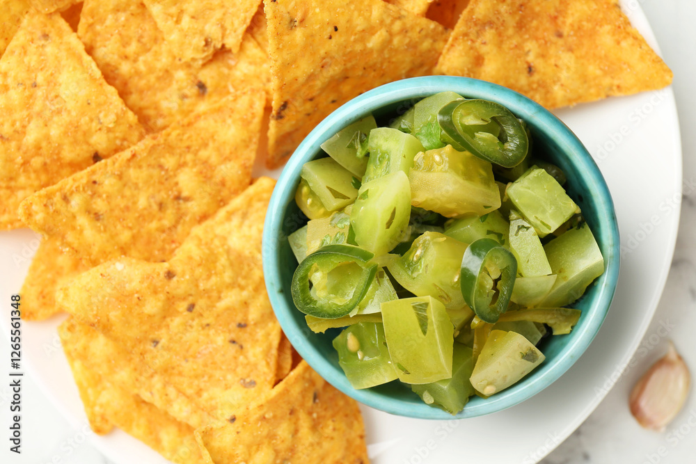 Delicious salsa with nachos on white table, top view Delicious salsa with nachos on white table, top view