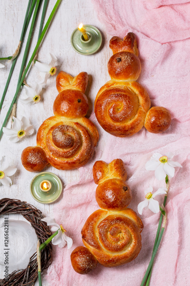 Easter composition made of rabbits, painted eggs and spring bouquets.