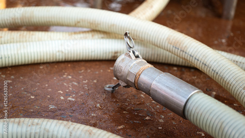 High pressure water jetting hose with metal nozzle head. Industrial equipment object, close-up.
