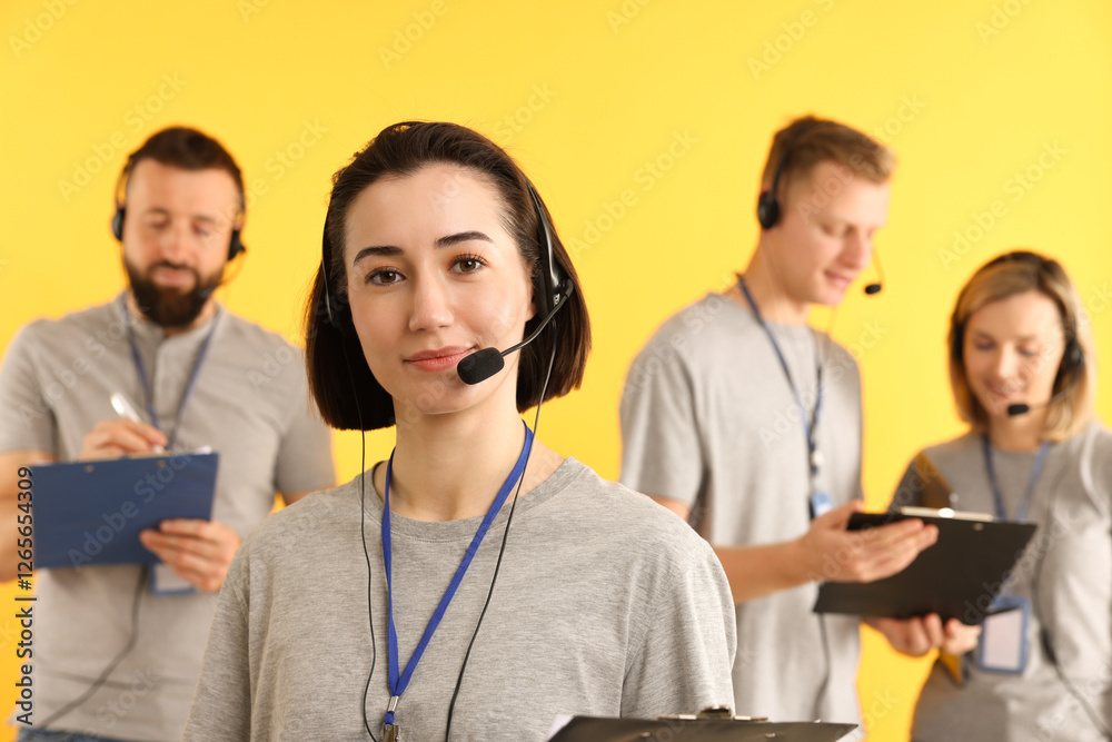Technical support call center. Team of friendly operators on yellow background Technical support call center. Team of friendly operators on yellow background