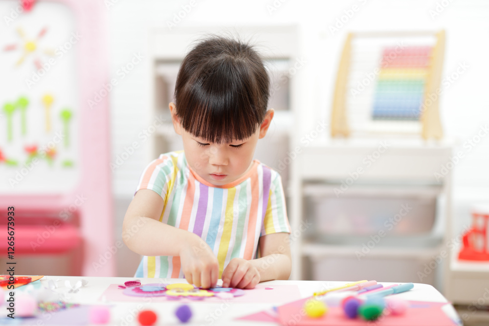 A young girl was creating a craft at home A young girl was creating a craft at home