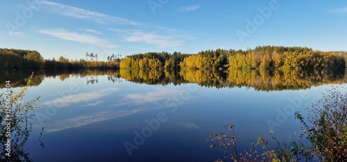 Canvas Print Hubenov Reservoir with its calm, mirror-like surface reflects the surrounding landscape, creating a serene and picturesque scene