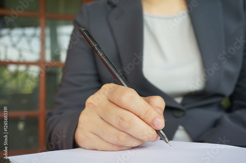 Accountant Working women writing with Spreadsheet document information financial concept at office selected focus on eyeglasses