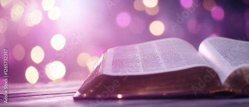 Open book, purple bokeh background, faith