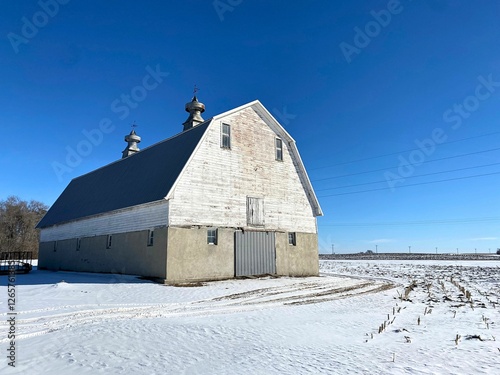 A well built barn structure with its cinderblock foundation in the snow