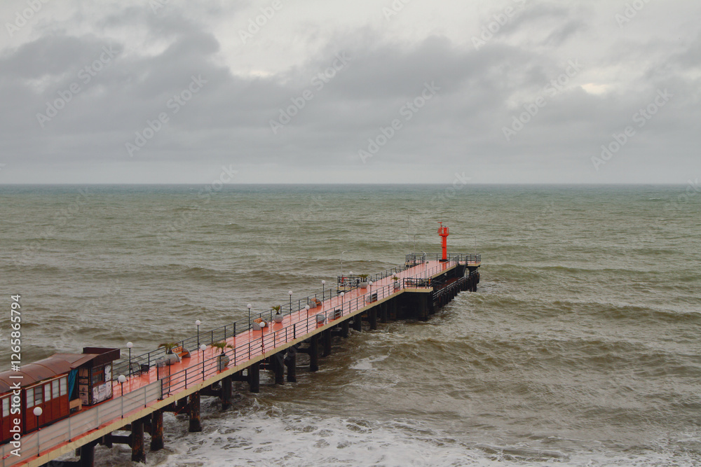 Pier and sea in bad weather. Adler, Sochi, Russia