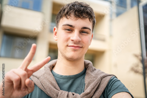 portrait of young Caucasian man teenager 18 or 19 years old outdoor photo