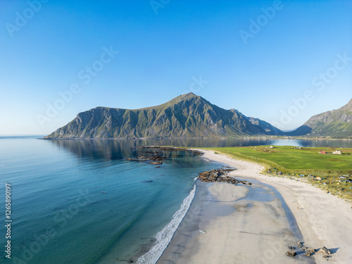 Aerial view overlooking Skagsanden Beach near Flakstad. In the background, the summit of Hustinden. Lofoten District in Norway photo