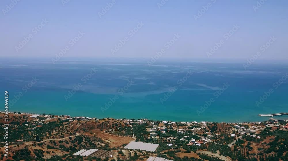 Breathtaking Panoramic View of the Endless Sea, Village, and Olive Groves in Crete Breathtaking Panoramic View of the Endless Sea, Village, and Olive Groves in Crete