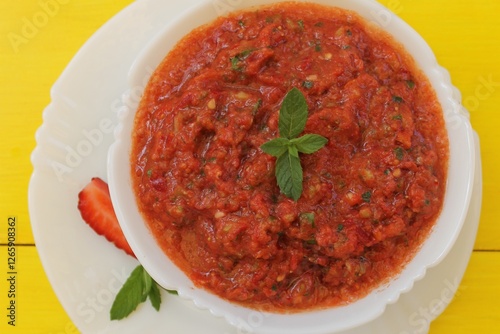 Gazpacho is a classic Spanish tomato soup flavored with mint, garlic, spices, and herbs. A must-try!