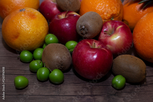 Fototapeta Naklejka Na Ścianę i Meble -  different fruits on wooden background close up