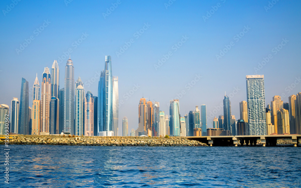 Dubai Marina beach skyscrapers, view at sunset from the boat Dubai Marina beach skyscrapers, view at sunset from the boat