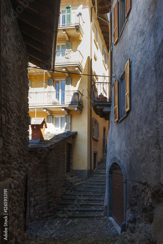 Obraz na płótnie Street view of historical village Gromo, Bergamo, Lombardy, Italy. Narrow cobbled streets. Sun lights and shadows. w salonie