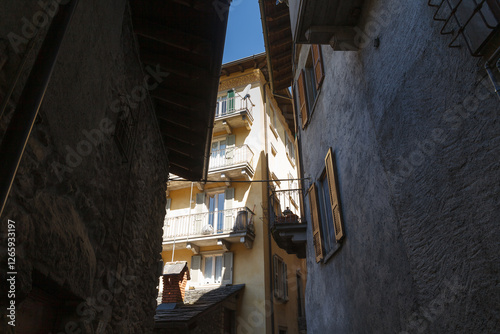 Obraz na płótnie Street view of historical village Gromo, Bergamo, Lombardy, Italy. Narrow cobbled streets. Sun lights and shadows. w salonie