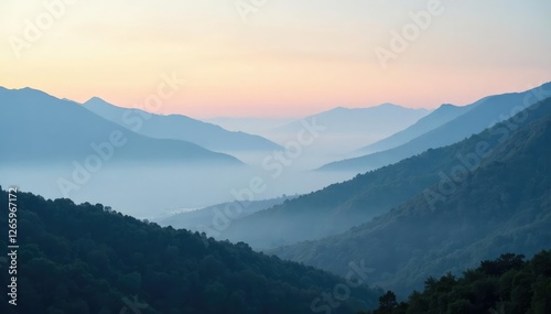 Foggy landscape with misty mountains in distance, cloudy horizon, fog