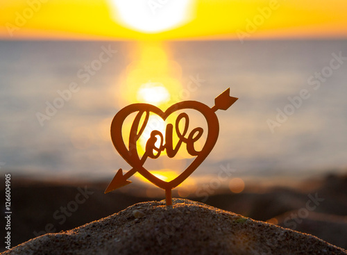 Black silhouette of stick with the words Happy Birthday in rectangular frame on background of sea and sea waves during sunset sunrise with sunrise or setting sun close-up. Concept holiday celebration photo