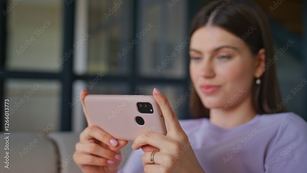 Chilling brunette watching cellphone video sitting sofa closeup. Woman relaxing Chilling brunette watching cellphone video sitting sofa closeup. Woman relaxing