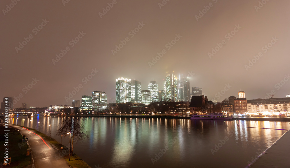 Fototapeta premium Frankfurt skyline at night across the Main river