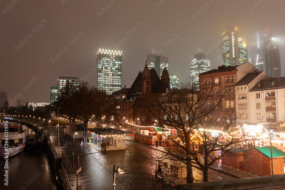 Fototapeta premium Cityscape with illuminated buildings, bridge, and Ferris wheel at night