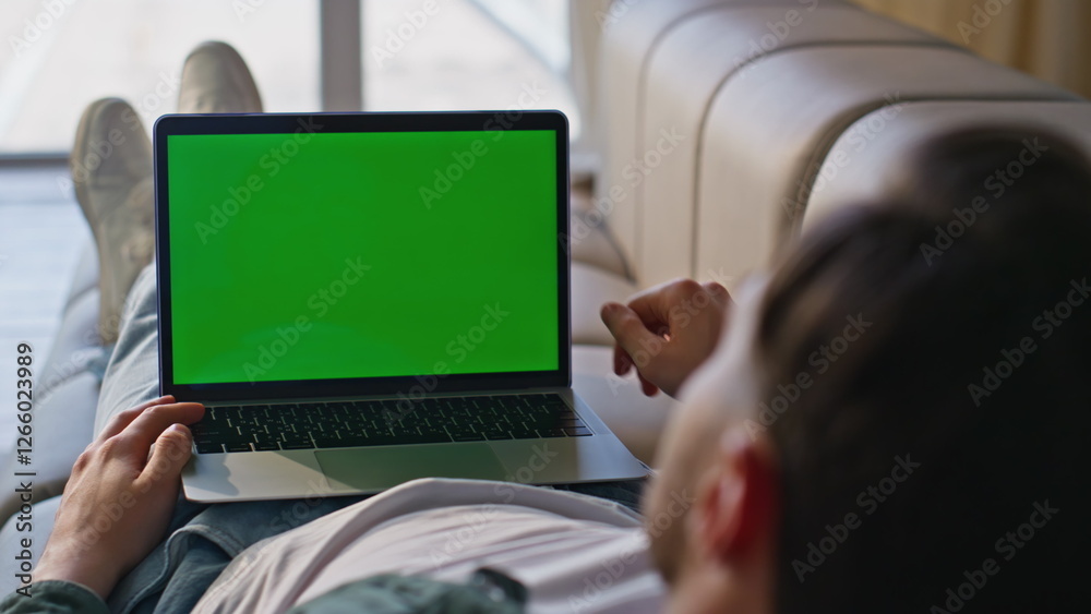 Freelancer using mockup laptop resting home sofa closeup. Man working computer Freelancer using mockup laptop resting home sofa closeup. Man working computer