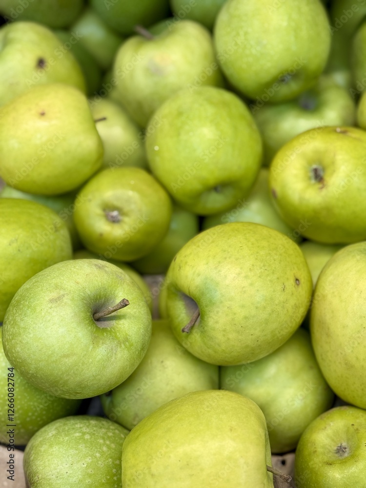 Box filled with fresh natural bio organic green apples placed on counter in local food market. Close-up Box filled with fresh natural bio organic green apples placed on counter in local food market. Close-up