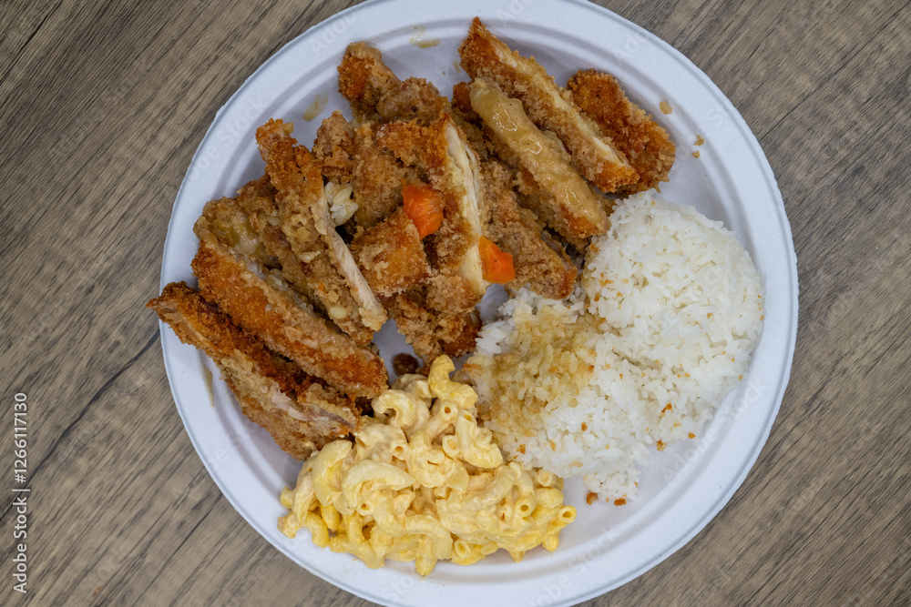 Take-out order of crispy katsu chicken served with rice and macaroni salad on a paper plate Take-out order of crispy katsu chicken served with rice and macaroni salad on a paper plate