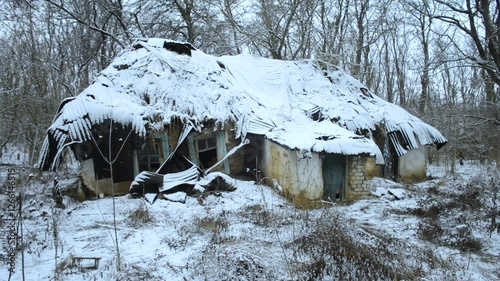 Old abandoned house,winter video landscape, house with damaged, winter day in the woodlands with old cabin. Snow covered trees . Mysterious place 
