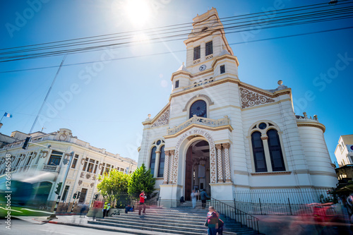 Low angle views of a beautiful colonial church with a blue sky in the background. photo