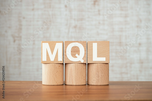 There is wood cube with the word MQL. It is an abbreviation for Marketing Qualified Lead as eye-catching image. photo