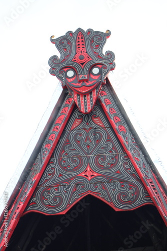 batak toba traditional house with gorga carving ornament photo