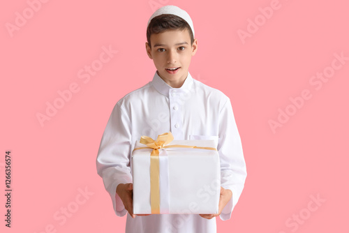 Little Muslim boy with gift...