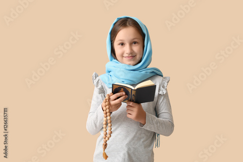 Little Muslim girl with Qur...