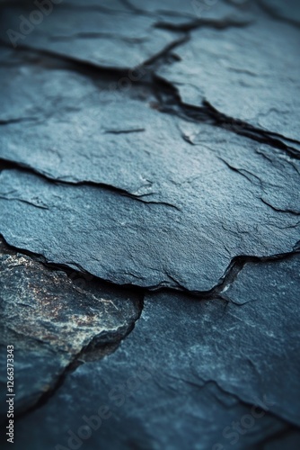 Close-up of dark blue slate stone texture with layered, rough surface and subtle color variations.