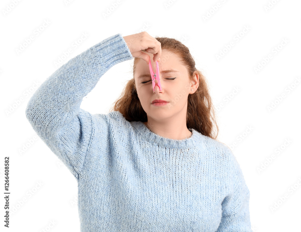 Ill young woman with clothespin on her nose against white background. Stuffy nose concept Ill young woman with clothespin on her nose against white background. Stuffy nose concept