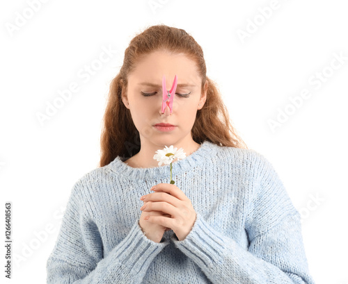 Ill young woman with clothespin on her nose and daisy flower against white background. Stuffy nose concept